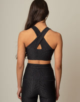 woman wearing chic black animal printed crop top on grey background