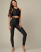 woman wearing chic black animal printed crop top on grey background