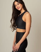 woman wearing chic black animal printed crop top on grey background