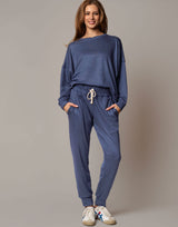 Woman wearing a blue outfit with a plain background