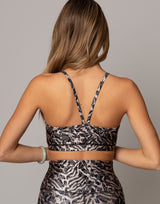 Woman wearing a patterned dress with a neutral background