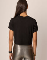 woman wearing black t-shirt on grey background