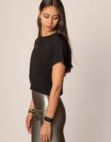 woman wearing black t-shirt on grey background