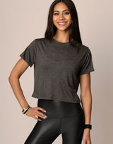 woman wearing essential tee, t-shirt, in charcoal color on grey background