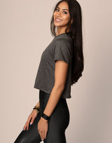 woman wearing essential tee, t-shirt, in charcoal color on grey background
