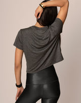 woman wearing essential tee, t-shirt, in charcoal color on grey background