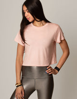 woman wearing pink colored t-shirt on grey background