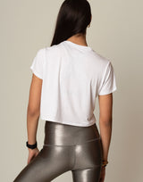 woman wearing white t-shirt on grey background