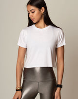 woman wearing white t-shirt on grey background