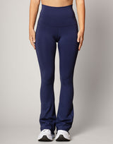 woman wearing flare legging in ink navy on grey background