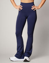 woman wearing flare legging in ink navy on grey background