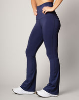 woman wearing flare legging in ink navy on grey background
