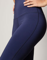woman wearing flare legging in ink navy on grey background