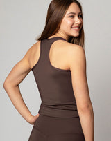 woman wearing chocolate brown colored tank top on grey background