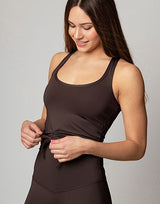 woman wearing chocolate brown colored tank top on grey background