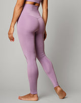 woman wearing legging in lavender purple on grey background