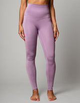 woman wearing legging in lavender purple on grey background