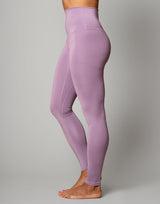 woman wearing legging in lavender purple on grey background