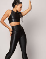 Person wearing a black shimmer outfit on a plain background