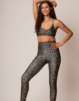 woman wearing leopard print sports bra against grey background