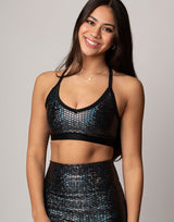 woman wearing sports bra with mermaid pattern of midnight black colored sparkling fish scales on grey background