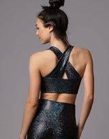 woman wearing crop top with mermaid pattern of midnight black colored sparkling fish scales on grey background