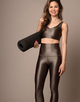 woman wearing high shine mocha colored sports crop on grey background
