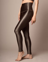 woman wearing high shine mocha color legging on grey background