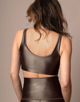 woman wearing high shine mocha colored sports crop on grey background