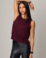 woman wearing burgundy colored tank on grey background