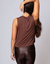 woman wearing chocolate brown colored tank on grey background