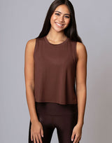 woman wearing chocolate brown colored tank on grey background