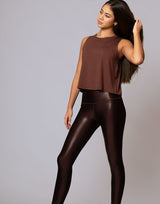 woman wearing chocolate brown colored tank on grey background
