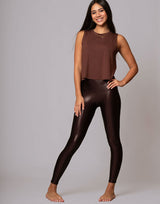woman wearing chocolate brown colored tank on grey background