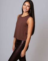 woman wearing chocolate brown colored tank on grey background
