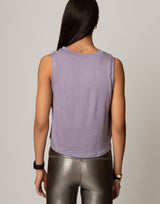 woman wearing lavender colored tank on grey background