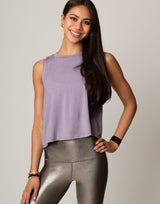 woman wearing lavender colored tank on grey background