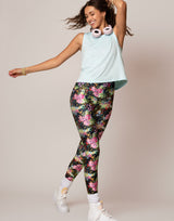 woman wearing vivid and colorful floral designs printed legging and tank top in cloud blue on grey background
