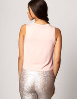 woman wearing tank top in pink on grey background