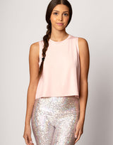 woman wearing tank top in pink on grey background