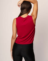 woman wearing ruby red colored tank on grey background