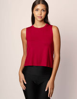 woman wearing ruby red colored tank on grey background