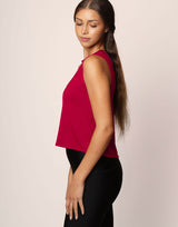 woman wearing ruby red colored tank on grey background