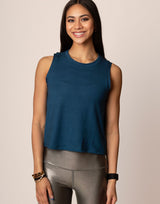 woman wearing teal colored tank on grey background