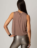 woman wearing toffee colored tank on grey background