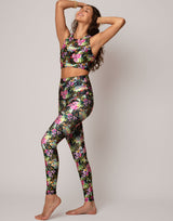 woman wearing vivid and colorful floral designs printed legging on grey background