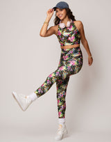 woman wearing vivid and colorful floral designs printed legging on grey background