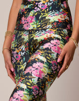 woman wearing vivid and colorful floral designs printed legging on grey background