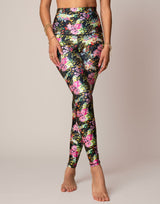 woman wearing vivid and colorful floral designs printed legging on grey background