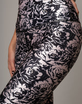 Black and white floral patterned pants on a neutral background